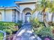 Inviting home entrance with beautiful walkway and lush landscaping at 4239 Corso Venetia Blvd, Venice, FL 34293