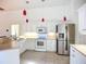 Bright kitchen with white cabinets, stainless steel appliances, and tile flooring at 4239 Corso Venetia Blvd, Venice, FL 34293