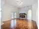 Bright living room featuring a modern fireplace and hardwood flooring at 4239 Corso Venetia Blvd, Venice, FL 34293