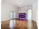 Cozy living room with hardwood floors, modern fireplace, and great natural light at 4239 Corso Venetia Blvd, Venice, FL 34293