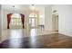 Open living area with tile and hardwood floors, arched windows, and a decorative chandelier at 4239 Corso Venetia Blvd, Venice, FL 34293