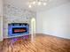 The living room features an accent wall with a modern electric fireplace, and beautiful hardwood flooring at 4239 Corso Venetia Blvd, Venice, FL 34293