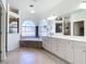 Large main bathroom with dual sinks, soaking tub, and a separate glass shower at 4239 Corso Venetia Blvd, Venice, FL 34293