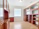 Office space featuring laminate flooring, large built-in cabinets, and a window for natural light at 4239 Corso Venetia Blvd, Venice, FL 34293