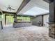 Outdoor covered bar area with stone counter and brick pavers, perfect for entertaining at 4239 Corso Venetia Blvd, Venice, FL 34293