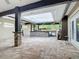 Expansive covered patio features a stunning stone bar, prep area, and tile flooring perfect for entertaining at 4239 Corso Venetia Blvd, Venice, FL 34293