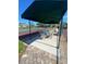 Relaxing patio near the tennis court with seating and shade for social time at 4239 Corso Venetia Blvd, Venice, FL 34293