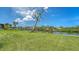 Backyard featuring well-maintained lawn and waterfront views at 4361 Pompano Ln, Palmetto, FL 34221