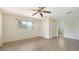The bedroom features tile floors, a ceiling fan, and an en suite bathroom at 4361 Pompano Ln, Palmetto, FL 34221