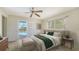 Bright bedroom featuring a ceiling fan and a sliding glass door with a pool view at 4361 Pompano Ln, Palmetto, FL 34221