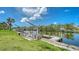 Waterfront property featuring a private dock with boat lifts and stunning views of the canal and surrounding nature at 4361 Pompano Ln, Palmetto, FL 34221
