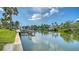 Waterfront view featuring private docks and boat lifts along a serene canal lined with lush tropical foliage at 4361 Pompano Ln, Palmetto, FL 34221