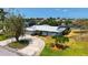 Home featuring a metal roof, lush landscaping, and a circular driveway at 4361 Pompano Ln, Palmetto, FL 34221