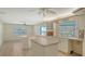 Bright eat-in kitchen features an island, a ceiling fan, tile floors, and views of the water at 4361 Pompano Ln, Palmetto, FL 34221