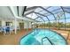 An enclosed pool area with a screen, clear blue water, and patio seating creating an inviting space at 4361 Pompano Ln, Palmetto, FL 34221