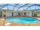 This screened-in pool area has a sparkling pool, comfortable seating, and a sunny lanai at 4361 Pompano Ln, Palmetto, FL 34221