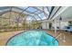 A screened-in pool area featuring a sparkling blue pool, stylish patio furniture, and serene outdoor living at 4361 Pompano Ln, Palmetto, FL 34221