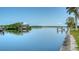 Tranquil waterfront vista highlighting private dock, a covered boat house, and serene canal waters at 4361 Pompano Ln, Palmetto, FL 34221