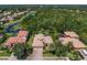 Stunning aerial view of a luxurious home surrounded by lush greenery and a serene lake, offering privacy at 4584 Tuscana Dr, Sarasota, FL 34241