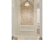 Arched bathroom niche featuring unique mosaic tile work and a shelf, adding a decorative touch at 4584 Tuscana Dr, Sarasota, FL 34241
