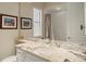 Bathroom features a marble countertop, framed mirrors, and shower-tub with gray tones at 4584 Tuscana Dr, Sarasota, FL 34241