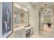 Chic bathroom featuring vanity with a large mirror, marble countertop and hallway view to a bedroom at 4584 Tuscana Dr, Sarasota, FL 34241