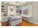 Bedroom with built-in shelves, wooden floors, and a window with plenty of light at 4584 Tuscana Dr, Sarasota, FL 34241