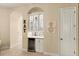 Elegant dining area featuring a built-in bar, wine cooler, and custom display cabinets with an arched doorway at 4584 Tuscana Dr, Sarasota, FL 34241