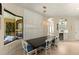Dining room with large windows and wall decor, blending seamlessly with a stylish bar area and wine cooler at 4584 Tuscana Dr, Sarasota, FL 34241
