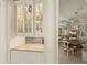 Modern dining room with decorative glass cabinet and an open concept floorplan leading to other living spaces at 4584 Tuscana Dr, Sarasota, FL 34241