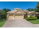 Charming two-story home featuring a three-car garage, a tile roof and lush landscaping at 4584 Tuscana Dr, Sarasota, FL 34241