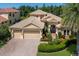 Beautiful two-story home with a three-car garage, arched entry, and manicured landscaping at 4584 Tuscana Dr, Sarasota, FL 34241