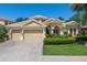 Beautiful home featuring a three car garage, well-manicured landscaping, and a welcoming front entrance at 4584 Tuscana Dr, Sarasota, FL 34241