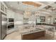 Modern kitchen featuring stainless steel appliances, a large granite island, and custom cabinetry at 4584 Tuscana Dr, Sarasota, FL 34241