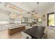 Open-concept kitchen with granite island, modern appliances, dining table, and a seamless flow into the living area at 4584 Tuscana Dr, Sarasota, FL 34241