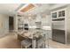 Bright kitchen with stainless appliances, granite island and custom cabinets offers a seamless flow to the upper level at 4584 Tuscana Dr, Sarasota, FL 34241