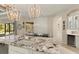 Stylish kitchen island with granite countertop and sink, open to dining area with seating and decor at 4584 Tuscana Dr, Sarasota, FL 34241
