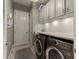 Functional laundry room with washer, dryer, cabinets, and countertop with tile backsplash at 4584 Tuscana Dr, Sarasota, FL 34241