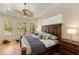 Spacious bedroom with a ceiling fan, hardwood floors, and backyard views from multiple windows at 4584 Tuscana Dr, Sarasota, FL 34241