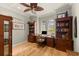 Cozy home office with wood flooring, custom built-in shelves, and arched windows at 4584 Tuscana Dr, Sarasota, FL 34241