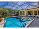 Inviting screened-in pool and spa with brick pavers and ample seating area; perfect for relaxation and entertaining at 4584 Tuscana Dr, Sarasota, FL 34241