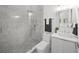 Bright bathroom featuring glass-enclosed shower with sleek gray marble, modern fixtures, and stylish vanity at 4726 Rivetta Ct, Sarasota, FL 34231