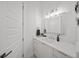 Well-lit bathroom featuring sleek vanity, a modern mirror, attractive decor, and a linen closet at 4726 Rivetta Ct, Sarasota, FL 34231