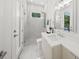Well-lit bathroom featuring glass-enclosed shower, modern fixtures, a stylish vanity and marble floors at 4726 Rivetta Ct, Sarasota, FL 34231
