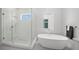 Bathroom with an egg-shaped tub, walk-in shower, and textured walls for a sleek, modern design at 4726 Rivetta Ct, Sarasota, FL 34231