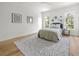 Serene bedroom featuring natural light from the large windows and beautiful floral artwork on the walls at 4726 Rivetta Ct, Sarasota, FL 34231