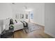 Modern bedroom features hardwood floors, white walls, and plenty of natural light at 4726 Rivetta Ct, Sarasota, FL 34231