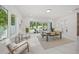 Bright dining area with floor-to-ceiling windows and a sliding glass door for seamless indoor/outdoor living at 4726 Rivetta Ct, Sarasota, FL 34231