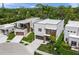 A stylish, two-story modern home that boasts landscaped grounds, wood accents and a convenient driveway at 4726 Rivetta Ct, Sarasota, FL 34231