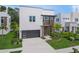 Modern home with a sleek design, featuring a dark garage door and tasteful landscaping at 4726 Rivetta Ct, Sarasota, FL 34231